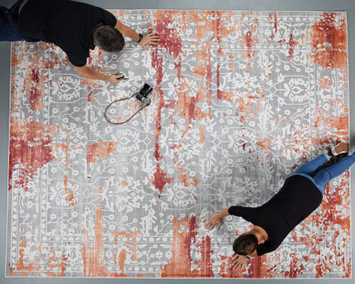 Preparation of rug product photoshoot on a grey background