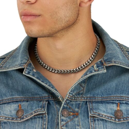 Half face shot of a male model wearing necklace for jewelry photography on a white background.