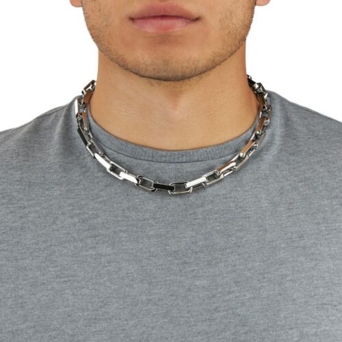 Half face shot of a male model wearing necklace for jewelry photography on a white background.
