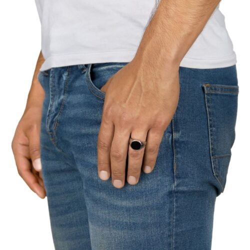 Half body shot of a male model posing for hand shot showcasing ring on a white background.
