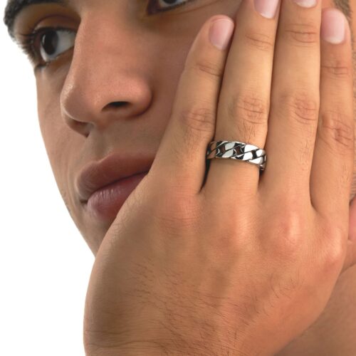 Closeup shot of a male model wearing a silver ring on a white background