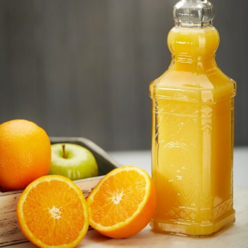 Glass Bottle of Orange Juice Photoshoot in a kitchen setup
