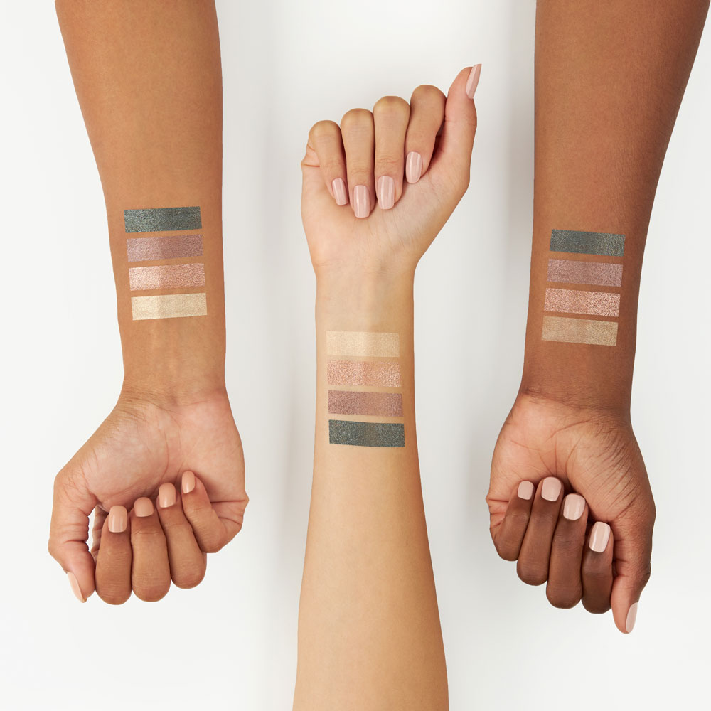 Cosmetics swatches on the arms of three different models