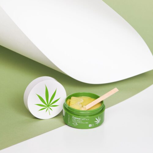 Beauty balm product shot on a green paper showing texture of the product