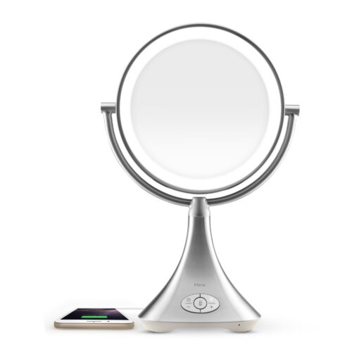 Hero shot of a rechargeable vanity mirror while charging a phone on a white background