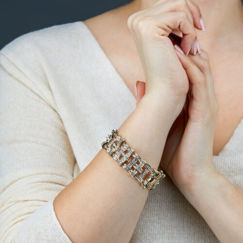 jewelry photography of a female model showing her hands wearing a bracelet.