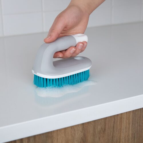 Blu scrub brush creative lifestyle photoshoot product photography with hand model