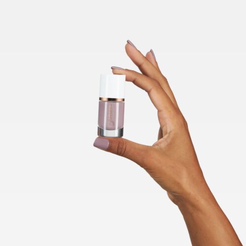 Commercial nail color product photoshoot on a white background with a model
