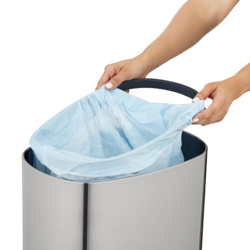 Female hand model putting plastic bag on a bin.