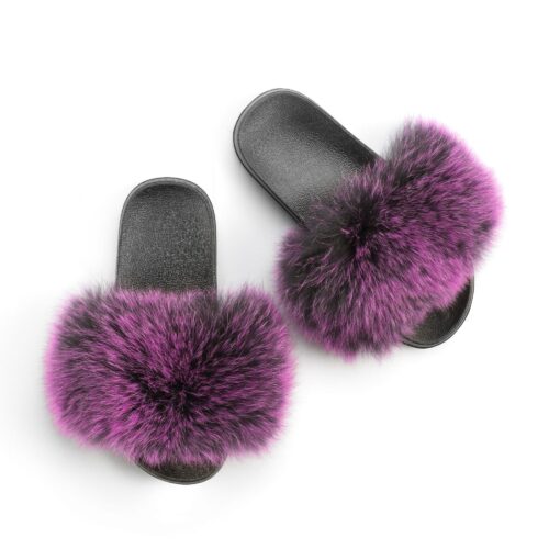 Overhead shot of purple fur slippers on a white background