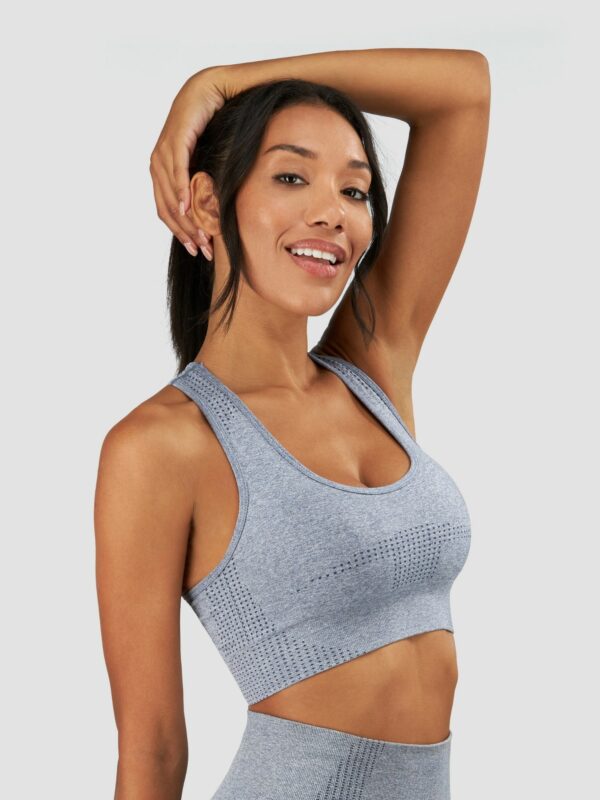 Clothing photography of a female black model wearing sports suit in grey