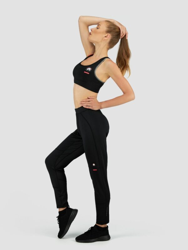 Clothing photography of a female white model wearing sports suit in black