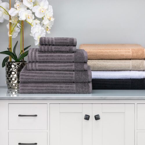 Composite shot of multi colored towels placed on a stock image with a flower vase.