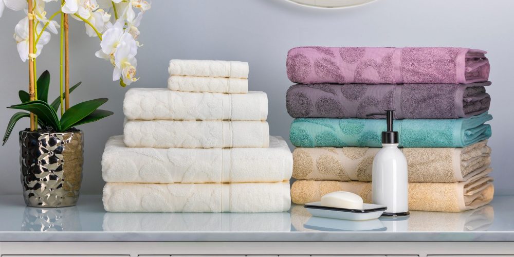 Composite shot of multi colored towels placed on a stock image with a flower vase.