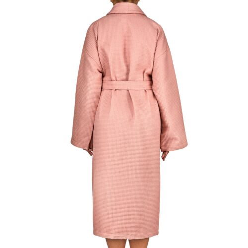 Clothing photoshoot back shot of a female model wearing a pink colored bath robe on a white background.