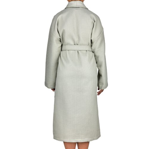 Clothing photoshoot back shot clothing photography of a female model wearing a bath robe on a white background.