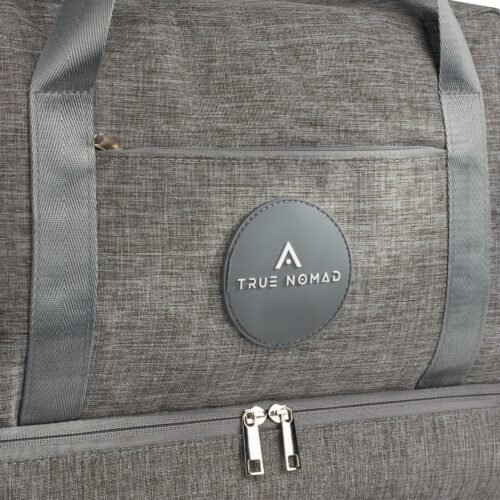 Closeup shot of a lucid grey colored travel bag with grey strips showing texture and logo of true nomad.