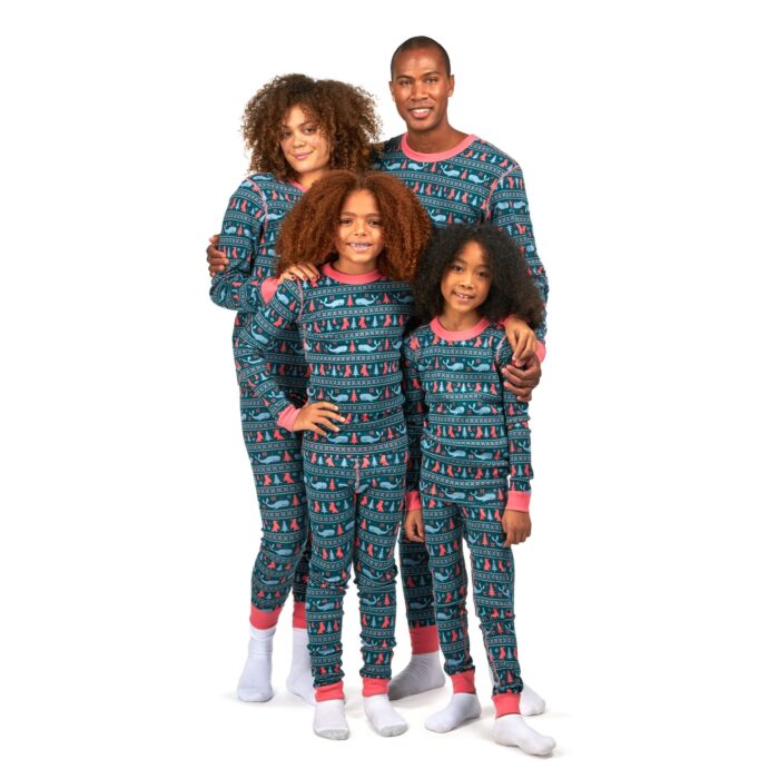 Husband, wife and two young girls wearing blue color pajamas and shirts posing for apparel photography on a white background.