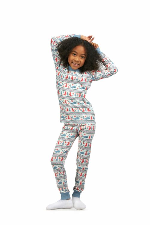 Female black child model with curly hairs posing and smiling for clothing photography shot on a white background.