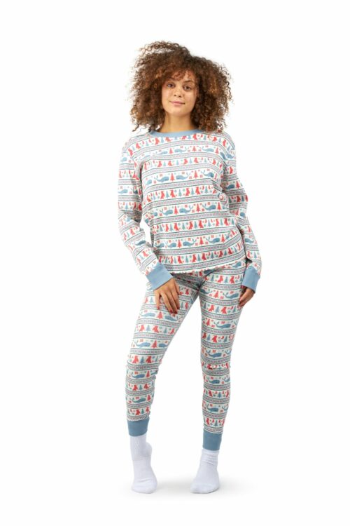Black female model with curly hairs posing for apparel photography wearing a pajama and shit on a white background.