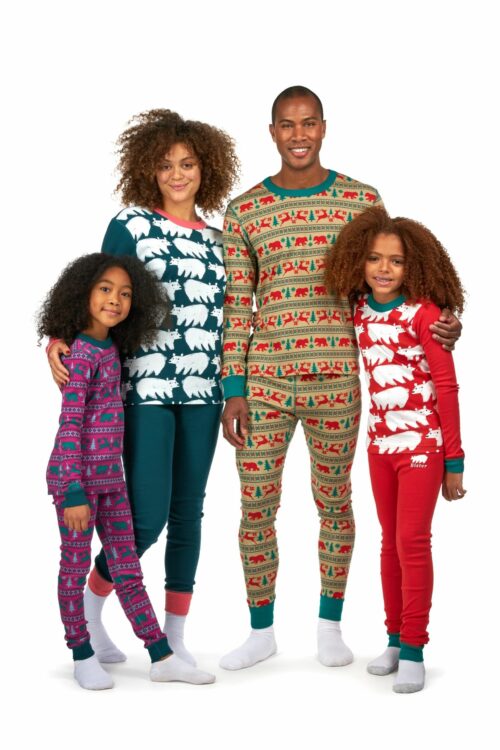 Clothing photography family shot of a black family with husband, wife and two female children with curly hairs on a white background.