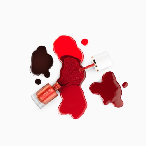 Creative nail polish photography using artsy pours setting with different shades of red shot by cosmetics photoshoot by Isa Aydin nj ny la