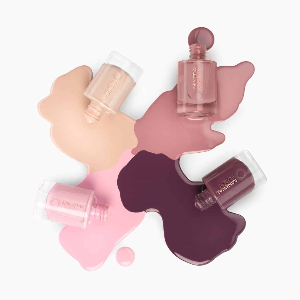 Creative artsy pours photography of 4 nail polish bottles with different colors shot by cosmetics photoshoot by Isa Aydin nj ny la