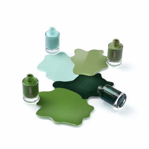 Artsy pours creative cosmetics photography of four nail polish bottles with different shades of green and blue by Isa Aydin nj ny la