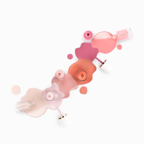 Artsy pours creative cosmetics photography of 8 small bottles of nail polish with different shades of colors by Isa Aydin nj ny la