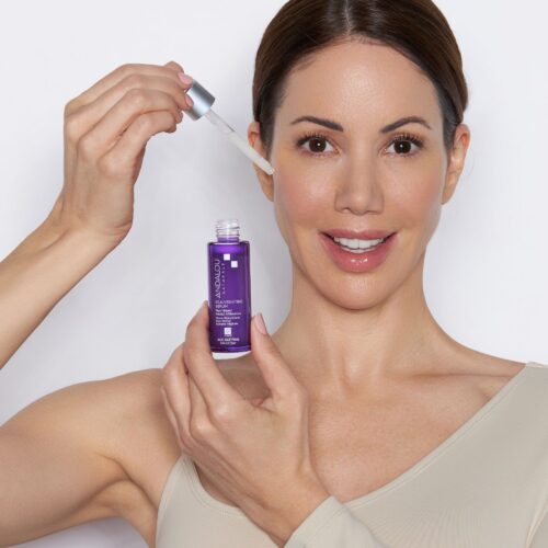 Skincare photo in white background with a model in action applying the product