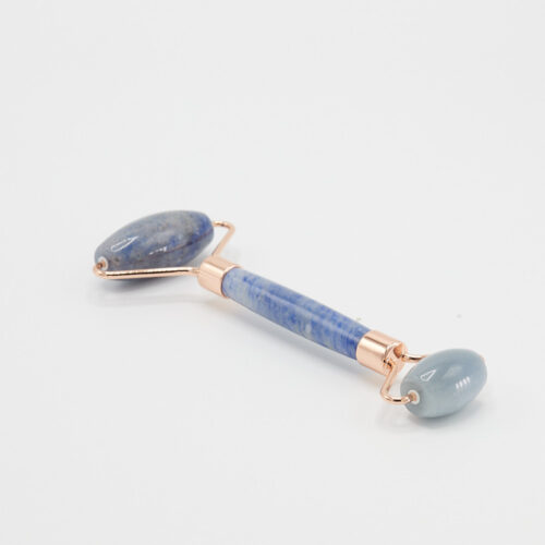 Light blue face roller product photoshoot on a white background by Isa Aydin nj ny la