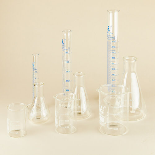 Lab glassware props set on a beige background by Isa Aydin nj ny la