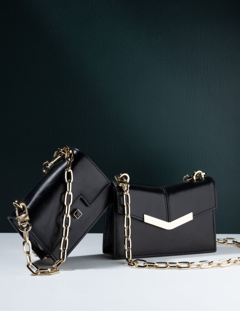 bags product photography on. dark background black leather bag with gold chain