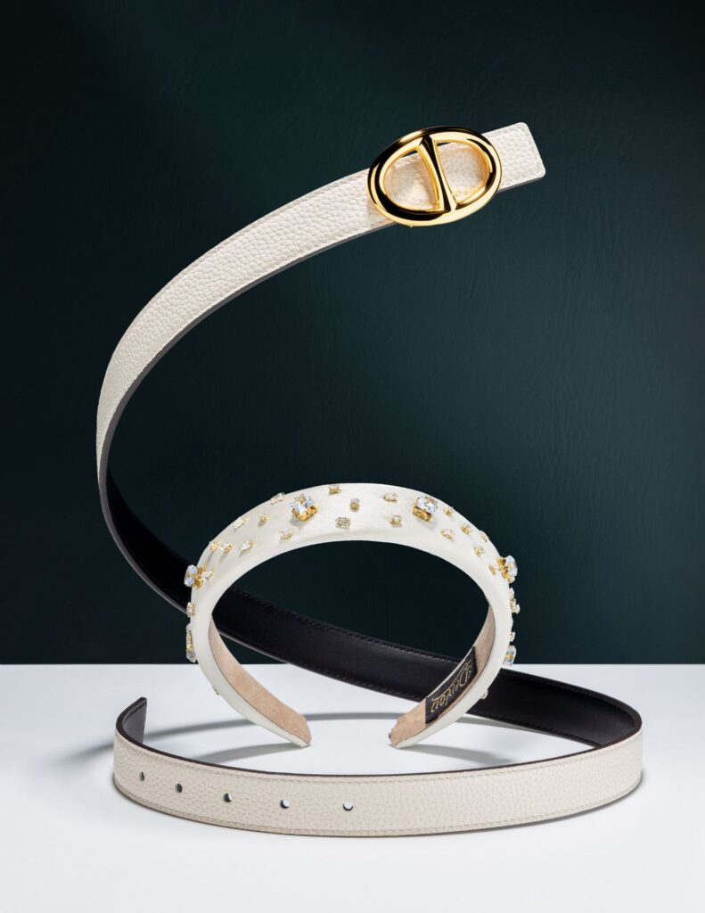 belt creative shot on dark green background witha. headband in the middle product fashion photography