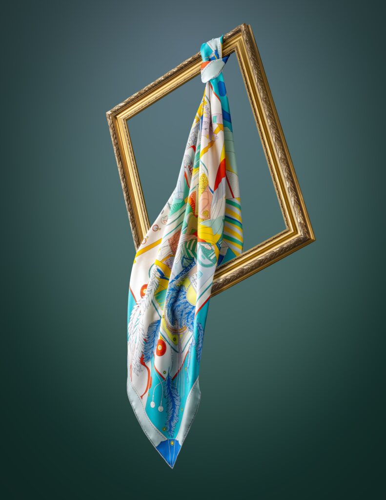 Product photography of scarves on golden frame and green background